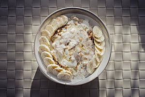 Granola with low-fat yogurt, banana honey and cinamon.