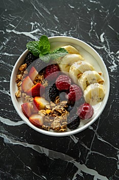 Granola muesli breakfast cereal, with milk and fresh fruit