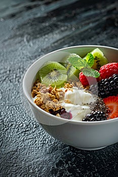 Granola muesli breakfast cereal, with milk and fresh fruit