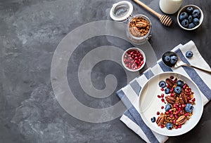 Granola, muesli with pomegranate seeds, blueberries and yogurt