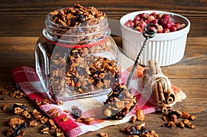 Granola in open glass jar and wild strawberries