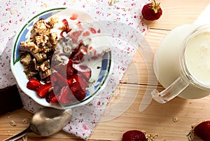 Granola with strawberries, yogurt and strawberry topping, milk j