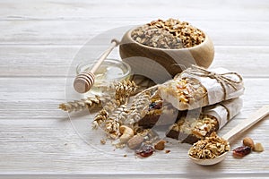 Granola superfood with almond and cashew nuts, dry fruits, raisins cherry in wooden bowl on the white wooden table, top view, brig