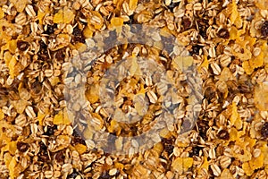 Granola texture - close-up of muesli flakes with raisins, nuts and dried fruits