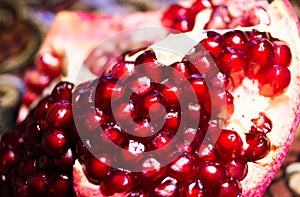 Grant. Exotic fruits. Ripe pomegranate. Pomegranate seeds. Red garnet. Grant close-up photo