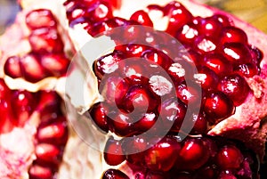 Grant. Exotic fruits. Ripe pomegranate. Pomegranate seeds. Red garnet. Grant close-up photo