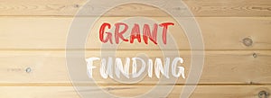 Grant funding symbol. Concept words Grant funding on beautiful wooden wall. Beautiful wooden wall background. Business and grant