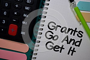 Grants Go and Get It write on a book isolated on Office Desk