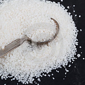 Granulated cassava tapioca on black background