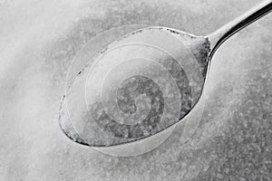 Granulated sugar on a spoon