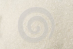 Granulated white textured Sugar sand as background.