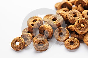 Granules of dry fodder in the shape of a rings. for dogs on a white background