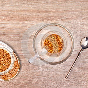 Granules of instant coffee in glass cup.