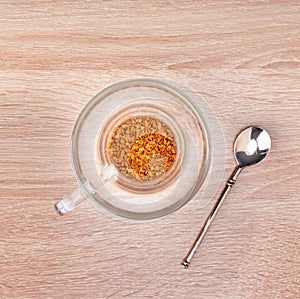 Granules of instant coffee in glass cup