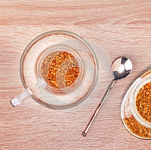 Granules of instant coffee in glass cup
