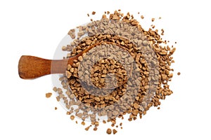 Granules of instant coffee in a wooden spoon isolated. Top view