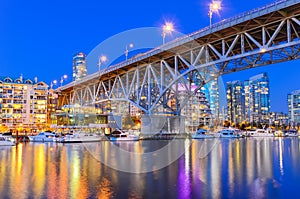 Granville Bridge and Vancouver BC skyline reflection at blue hour in Canada