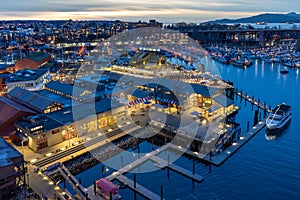 Granville Island Marina and Fishermen Wharf Float. Vancouver city buildings skyline in the background.