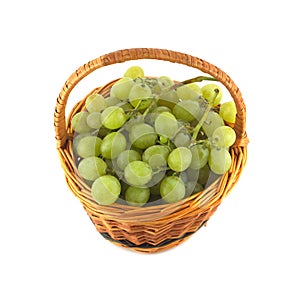 Grape bunch in wicker basket isolated close up