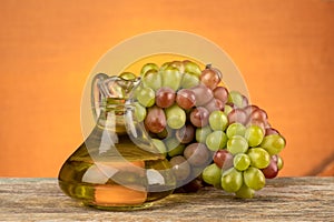 Grape fruits and oil on an oragne background