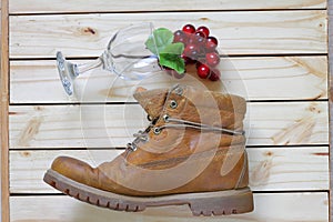 Grape and glass and boots on wood back ground.