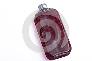 Grape juice in a clear bottle on a white background