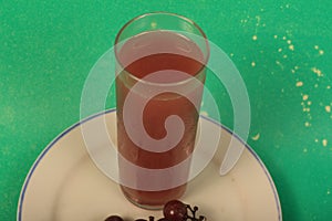 Grape juice on a green background