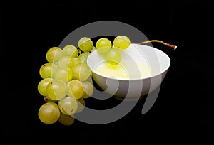 Grape seed oil with a bunch of white grapes