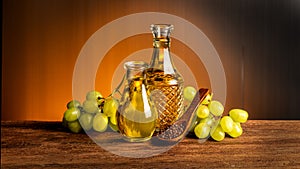 Grape seed oil and fruits on an old wooden background.