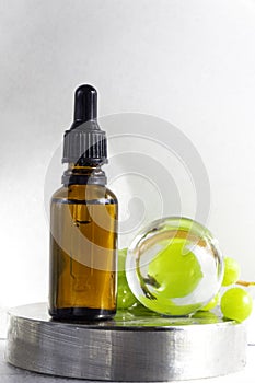 Grape seed oil in glass bottle with fresh grape