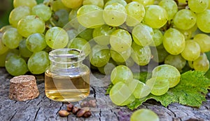 Grape seed oil in a glass jar and fresh grapes for spa and body care. The concept of spa, bio, eco products