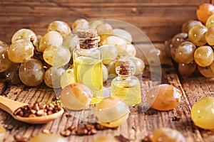 Grape seed oil in glass jar on wooden background. Selective focus