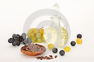 Grape seed oil and grape on white background