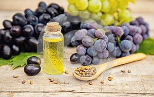 Grape seed oil in a small bottle. Selective focus