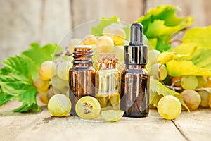 Grape seed oil in a small jar. Selective focus.