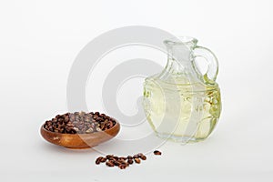 Grape seed in wooden bowl and grape seed oil in glass jar