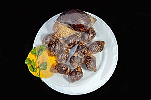 Grape snails, akhatina, on a plate, as crude food, a rawism