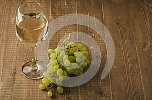 Grape and wine on wooden table/grape and wine on wooden table, selective focus and copy space