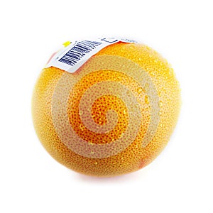 Grapefruit with bar code sticker and water drops