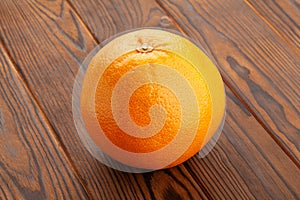 grapefruit on brown wood