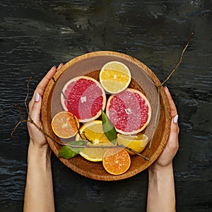 Grapefruit citrus fruit halves on wooden plate