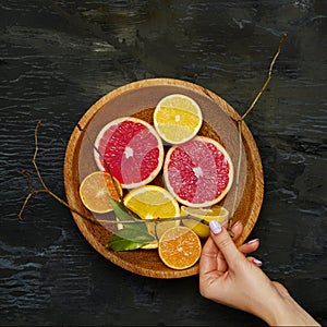 Grapefruit citrus fruit halves on wooden plate