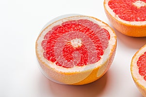 Grapefruit cut in halves on a white background. Useful tropical citrus diet fruit