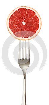 Grapefruit cut piece on impaled on a fork isolated on white background with clipping path