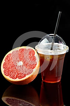 Grapefruit fresh in a plastic transparent glass