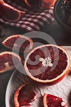 Grapefruit in half and slices on dark mood setup