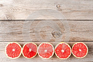 Grapefruit halves on wooden background with copyspace