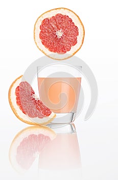 Grapefruit juice in glass isolated on white