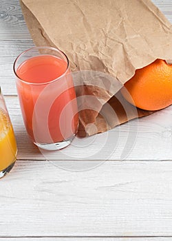 Grapefruit juice and grapefruit in a paper bag