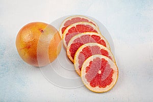 Close-up Grapefruit slices abstract background in Living Coral color of the Year 2020. Bright summer texture